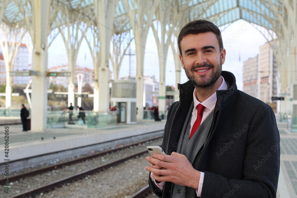 Businessman using internet from train station Businessman using internet from train station
