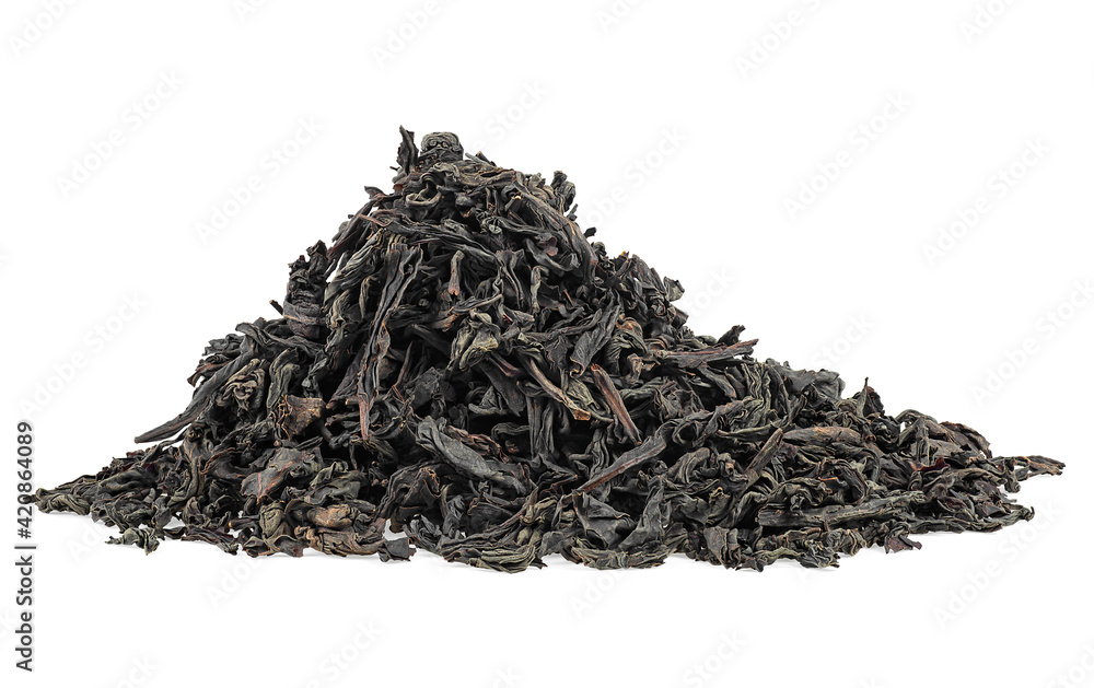 Dry black tea leaves isolated on a white background. Pile of black tea. Large leaf black tea. Dry black tea leaves isolated on a white background. Pile of black tea. Large leaf black tea.