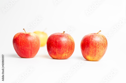 Red and yellow apples on white background © LilianC