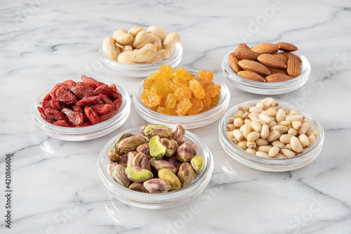 assorted dried seeds and fruit in glass saucers