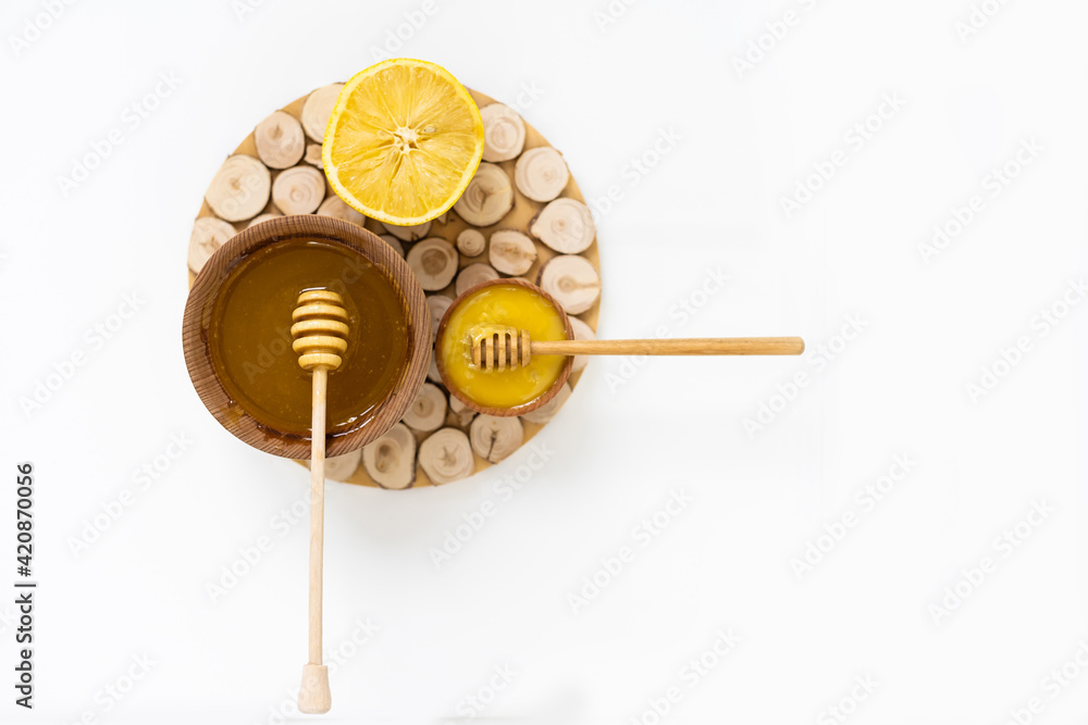 Bowl of honey on white background. Symbol of healthy living and natural medicine. Aromatic and tasty. Bowl of honey on white background. Symbol of healthy living and natural medicine. Aromatic and tasty.