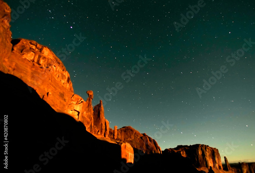 USA, Utah, Arches National Park. Moonrise highlights Park Avenue, with star p...
