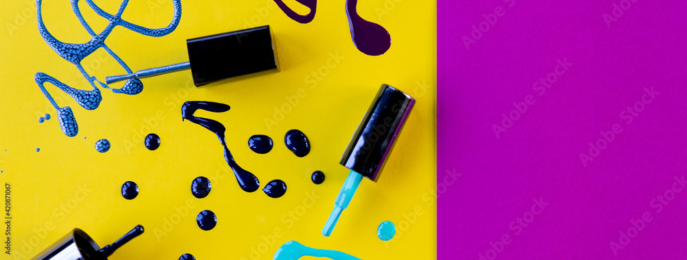Blots of purple, blue nail polish isolated on bright background.Nail Polish Splashes. art set. Blots of mixed multicolor samples.paint splash isolated on yellow. Web banner.copy space