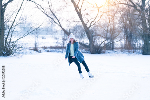 young woman skating on a frozen pond