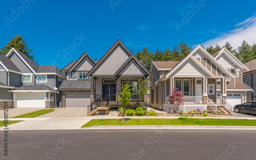 A perfect neighbourhood. Houses in suburb at Summer in the north America. Luxury houses with nice landscape.