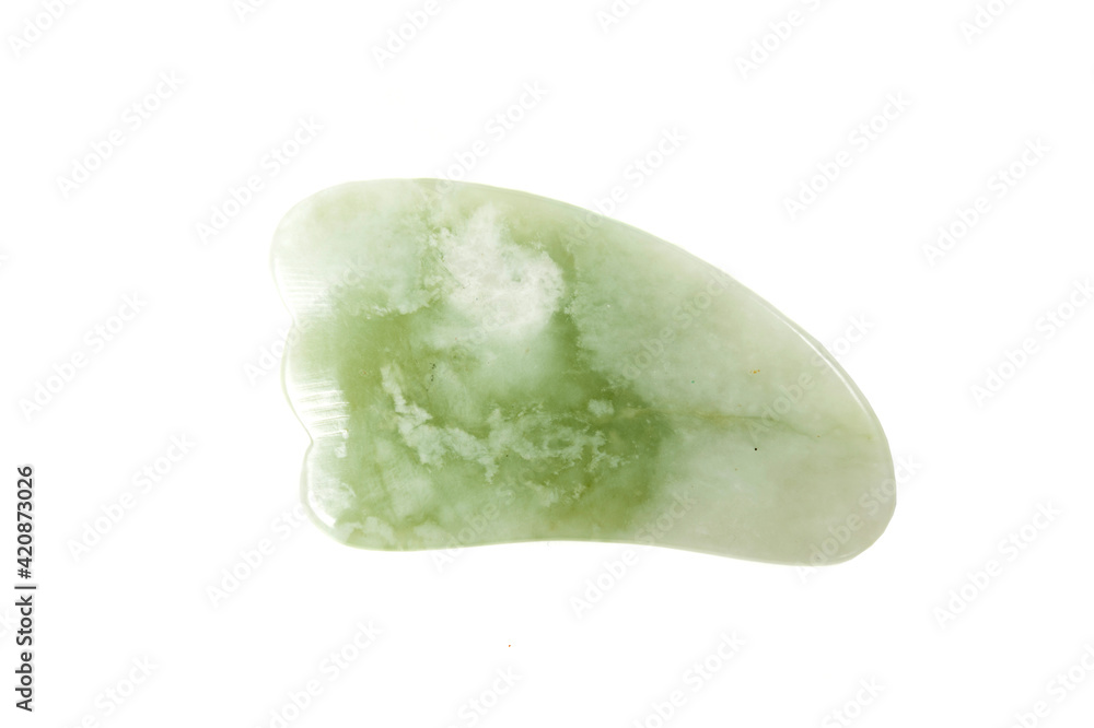 Jade guasha for spa treatments, massage stone on white background.Isolated.Chinese traditional massage - Gua Sha with stone.Jade massage scraper, gemstone . Jade guasha for spa treatments, massage stone on white background.Isolated.Chinese traditional massage - Gua Sha with stone.Jade massage scraper, gemstone .
