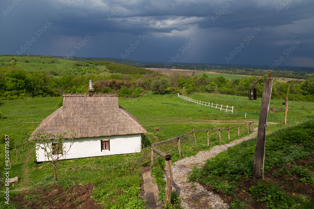 Ukrainian village against the backdrop of storm clouds Ukrainian village against the backdrop of storm clouds