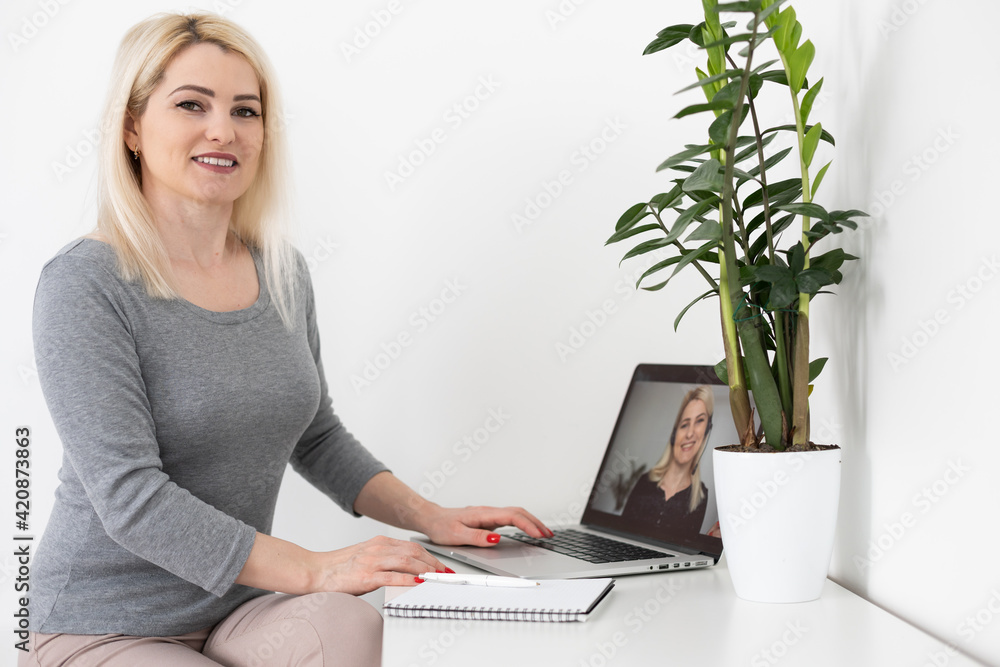 Back view of business woman talking to her colleagues about plan in video conference. business team using laptop for a online meeting in video call. Group of people smart working from home. Back view of business woman talking to her colleagues about plan in video conference. business team using laptop for a online meeting in video call. Group of people smart working from home.