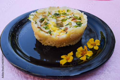 Popular and traditional Indian Rajasthani sweet item dessert called Ghevar or Ghewar photo