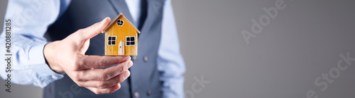 wooden house in male hand