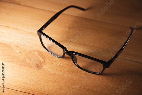 eye glasses on wooden desk
