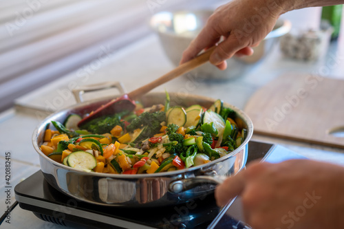 Cooking stir-fry, fresh chopped Mediterranean vegetables, at home during COVID-19 lockdown Gold Coast Queensland Australia