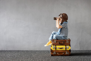 Happy child dreaming about summer vacation and travel