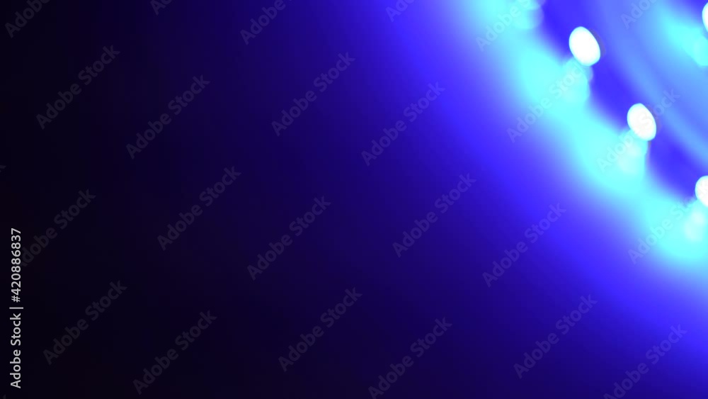 Led strip coil closeup. Diode shining stripe on dark blue background.