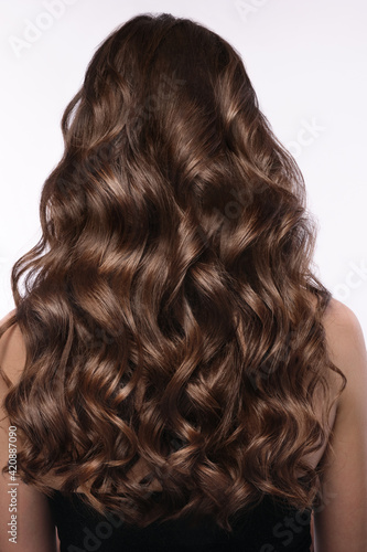 A closeup view of a bunch of shiny curls brown hair photo