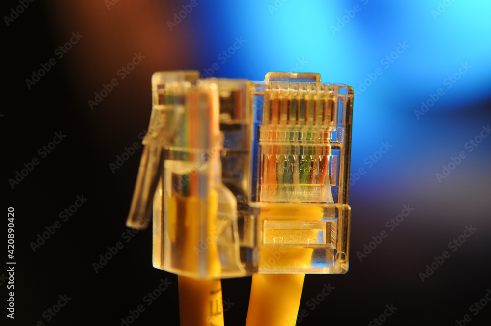 Φωτογραφία Close-up of two yellow Ethernet cables with transparent RJ45 connectors, represe