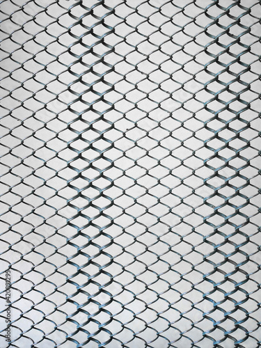 Old metal steel springy mesh with chain link on a beige background