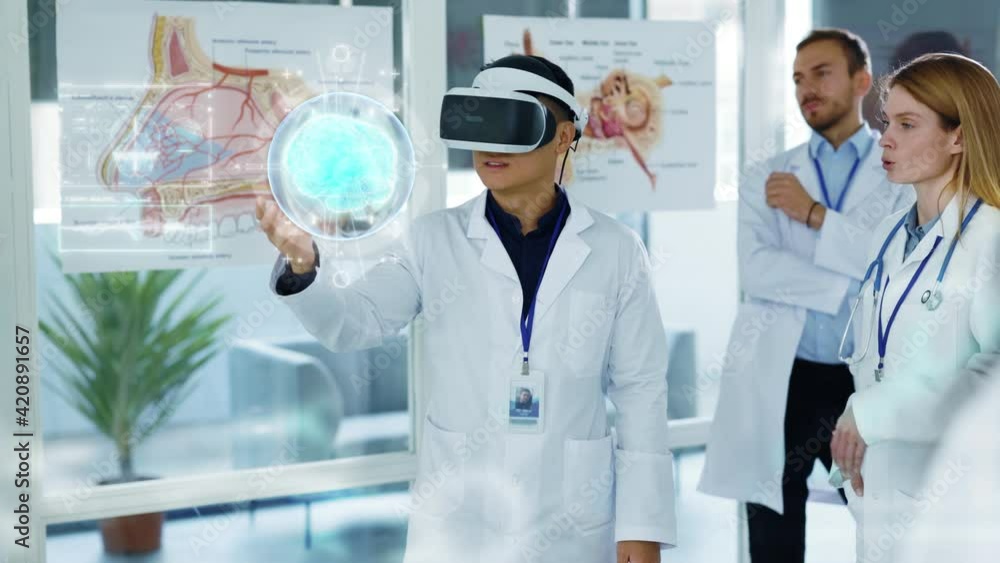Future Medicine. Doctors discussing Human Brain Surgery wearing Virtual Reality Glasses. High Tech Technologically. Brain Scan Tomography. Technologically Hospital. Artificial Intelligence Future Medicine. Doctors discussing Human Brain Surgery wearing Virtual Reality Glasses. High Tech Technologically. Brain Scan Tomography. Technologically Hospital. Artificial Intelligence