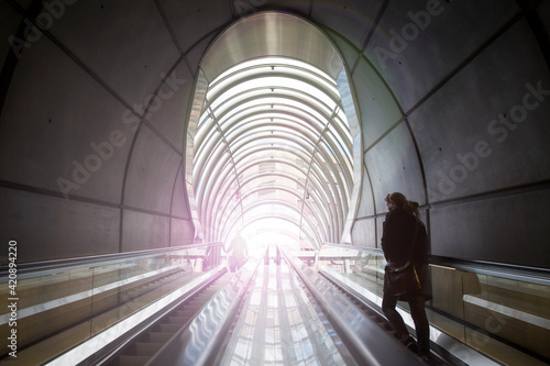 Rear view of woman ascending subway staircase in tunnel, Bilbao, Spain