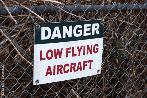 View of sign Caution Low Flying Aircraft at local airport in Courtenay, Canada