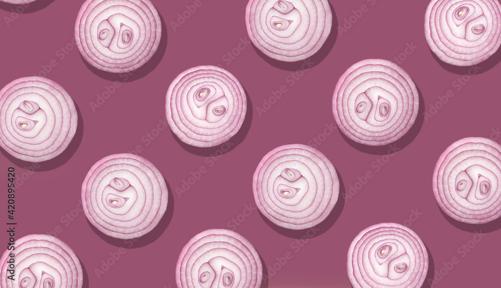 onion slices on purple background onion slices on purple background