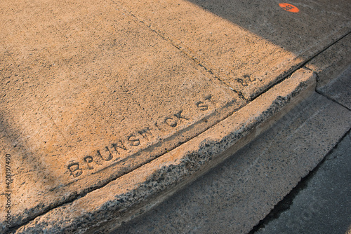 Words 'Brunswick St' engraved on pavement, Halifax, Canada