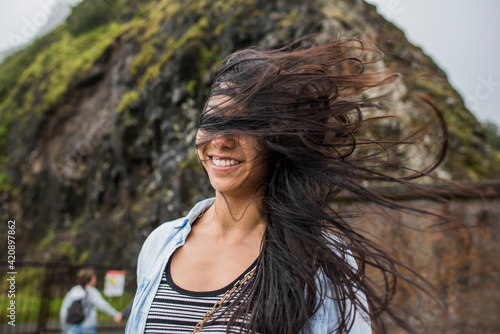 Woman with windswept hair, Nu‘uanu Pali Lookout, Oahu, Hawaii photo