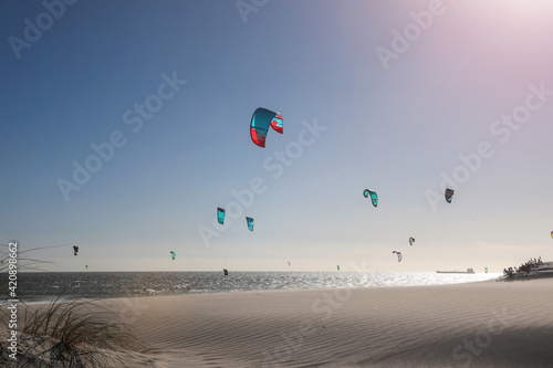 Group of kite surfers mid air over sea, Cape Town, Western Cape, South Africa photo