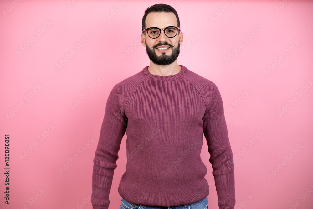 Handsome man wearing glasses and casual clothes over pink background with a happy face standing and smiling with a confident smile showing teeth Handsome man wearing glasses and casual clothes over pink background with a happy face standing and smiling with a confident smile showing teeth