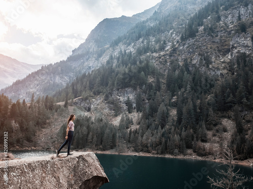 Woman enjoying view by lake, Antronapiana, Piemonte, Italy photo