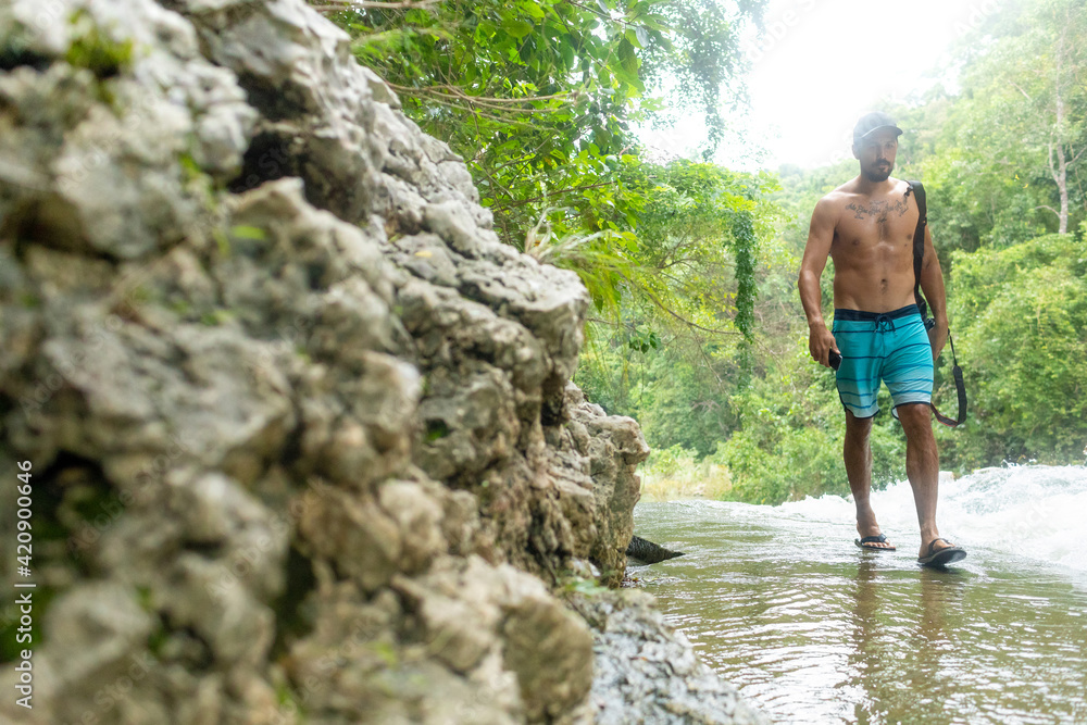 Man enjoying Tanap-Avis Falls, Bagui, Ilocos Norte, Philippines Man enjoying Tanap-Avis Falls, Bagui, Ilocos Norte, Philippines