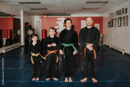 Coaches and students posing in martial arts studio