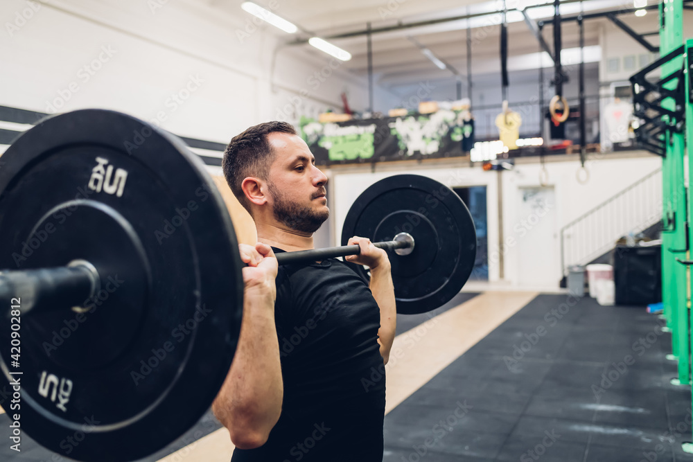 Man weight training in gym Man weight training in gym