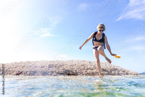 Woman exploring seaside, Ginto island, Linapacan, Philippines photo