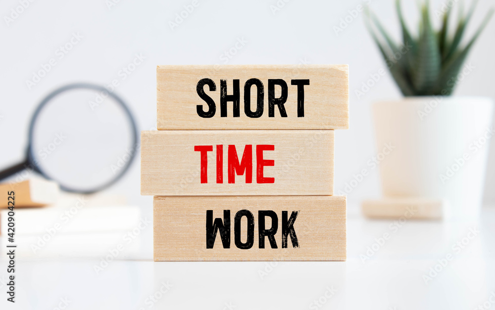 SHORT TIME WORK. text on wooden block SHORT TIME WORK. text on wooden block