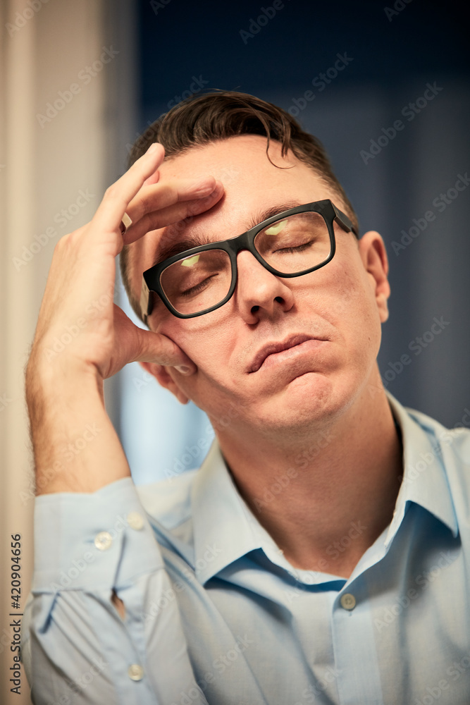 Man resting on elbow with eyes closed Man resting on elbow with eyes closed