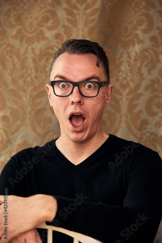 Comedian widening eyes in awe