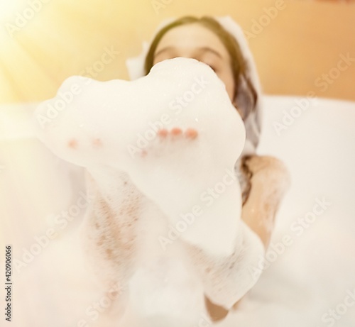 bath foam. baby hands in bubble bath, baby washing in bubble bath