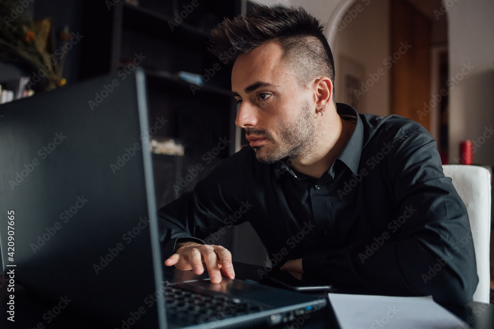 Man using laptop in home office Man using laptop in home office