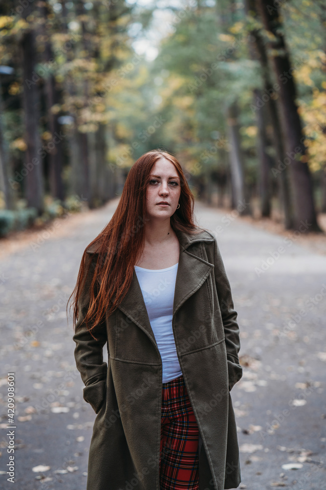 Young woman with long red hair in autumn park, portrait Young woman with long red hair in autumn park, portrait