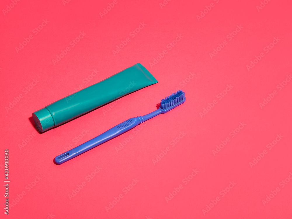 Toothbrush and toothpaste on red background Toothbrush and toothpaste on red background