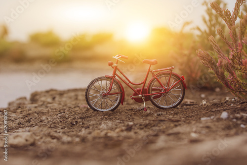 Red bicycle parking outdoor in nature summer holiday sunset background copy spec