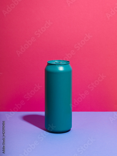 Still life of turquoise drink can and pink background photo