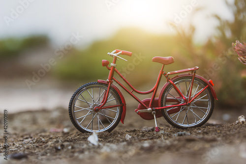 Red bicycle parking outdoor in nature summer holiday sunset background copy spec