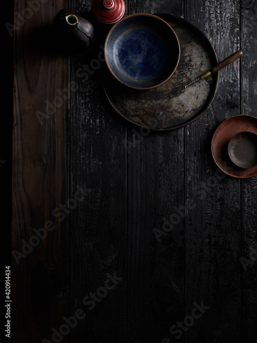 Snuff bottles, small dishes, dabber tool on wooden table photo