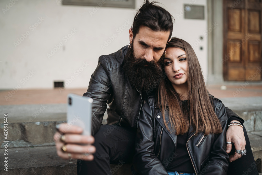 Couple taking selfie on steps Couple taking selfie on steps