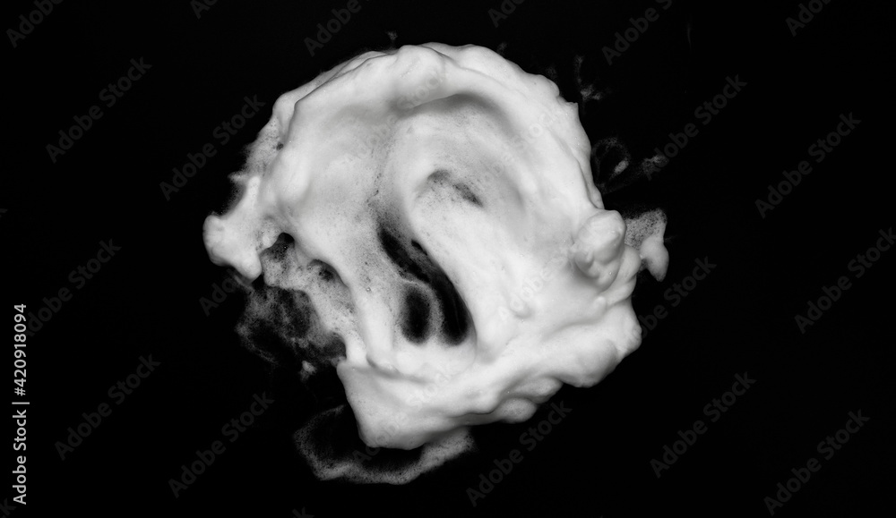 White soapy foam texture. Shampoo foam with bubbles.White facial foam creamy bubble soap sponge isolated on black background. White soapy foam texture. Shampoo foam with bubbles.White facial foam creamy bubble soap sponge isolated on black background.