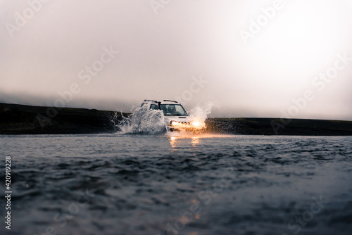 Off road vehicle driving in river, Landmannalaugar, Iceland