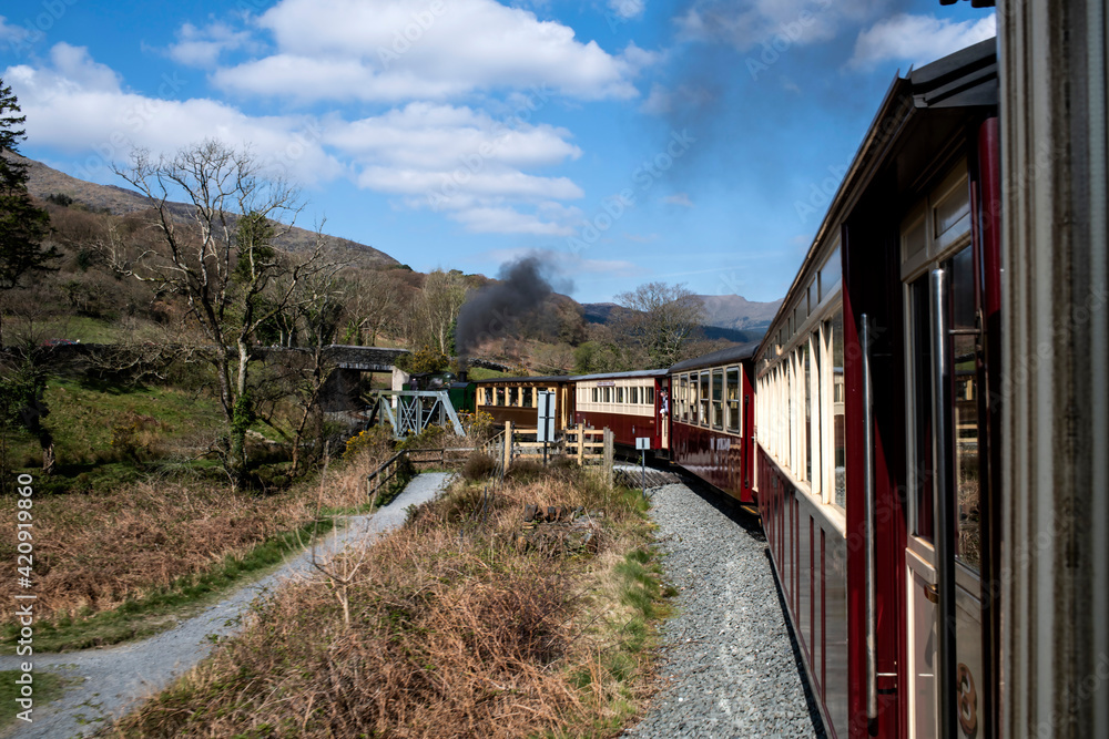 Steam train passing through countryside, Llanaber, Gwynedd, United Kingdom Steam train passing through countryside, Llanaber, Gwynedd, United Kingdom