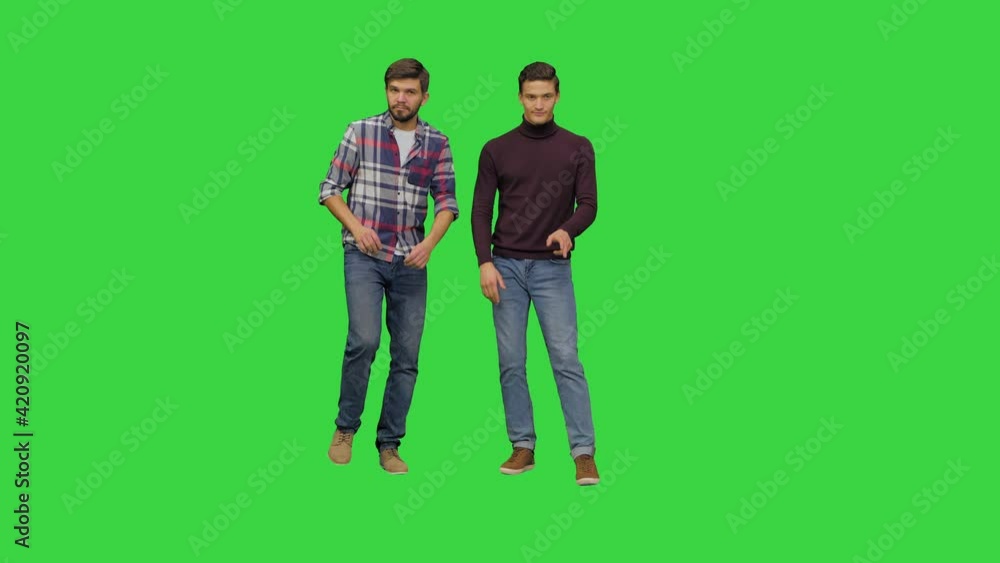 Two young men dancing in a funny awkward way on a Green Screen, Chroma Key. Two young men dancing in a funny awkward way on a Green Screen, Chroma Key.